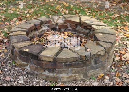 Outdoor stone block fire pit in public park or backyard Stock Photo