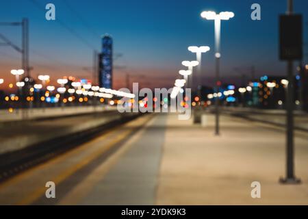 Bokeh of night lights on defocused railway platform in city. Stock Photo