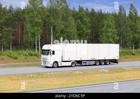 White DAF XF 460 truck in front of Ekeri FRC temperature controlled box semi trailer at speed on motorway. Salo, Finland. June 16, 2020 Stock Photo