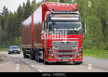 Jyvaskyla, Finland. June 7, 2019. Beautifully customized new red Volvo FH16 truck with full trailer of Konnekuljetus Oy hauls goods along highway Stock Photo