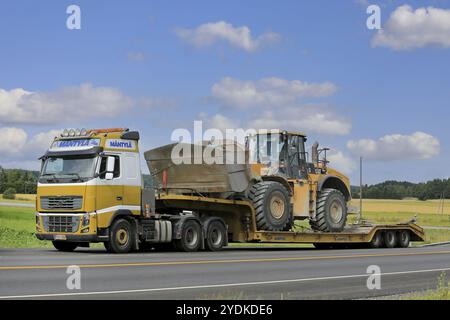 SALO, FINLAND, JULY 30, 2016: Yellow Volvo FH16 semi of Mantyla E & E in heavy equipment haul stops for a moment by road in South of Finland. The truc Stock Photo