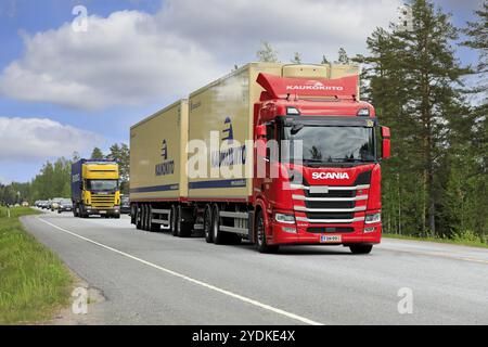 Red Scania R500 truck pulling temperature controlled multi axle trailer in traffic on road 25. Long transport. Raasepori, Finland. May 27, 2021 Stock Photo