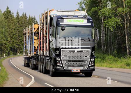 Black Volvo FH16 of Toivonen pulls full timber trailer along Highway 18 on a beautiful day of summer. Jyvaskyla, Finland. June 7, 2019 Stock Photo