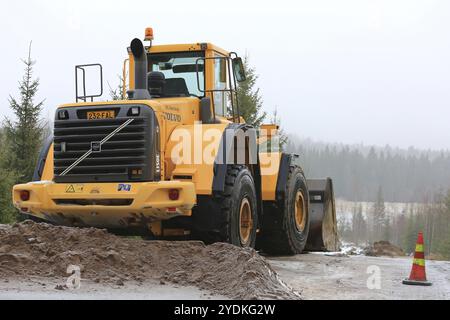 SOMERO, FINLAND, JANUARY 28, 2017: Volvo L150E wheel loader at road construction site on a cloudy, foggy day in winter Stock Photo