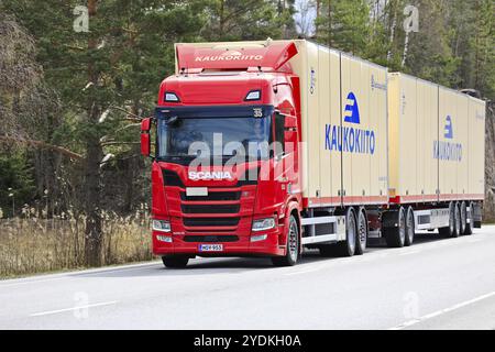 Red Scania 500R truck Kaukokiito pulling high capacity transport trailer in traffic on road 52. Salo, Finland. April 27, 2023 Stock Photo