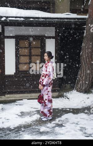 27.12.2017, Takayama, Japan, Asia, A young Japanese woman in a traditional kimono stands in a street while it snows, Asia Stock Photo