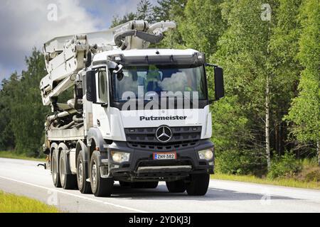 White Mercedes-Benz Arocs 3243 truck with truck mounted Putzmeister M28-4 Pumi concrete pump on road 25 in Raasepori, Finland. July 7, 2023 Stock Photo