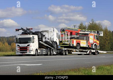 Next generation Scania G vehicle carrier truck of Scancargo Oy hauls two new lorries, one being a fire truck in Forssa, Finland. October 2, 2020 Stock Photo