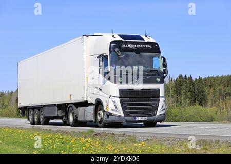 New, white Volvo FH 460 truck pulls FRC temperature controlled semi trailer along highway on a sunny day of spring. Forssa, Finland. May 19, 2023 Stock Photo