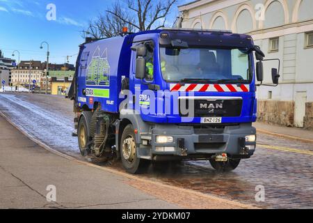 Blue MAN TGM 15.240 street washer truck of Stara, City of Helsinki City Construction Services, washing streets in Helsinki, Finland. May 12, 2020 Stock Photo