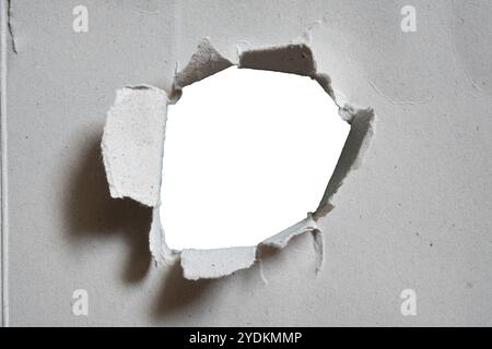 Gray paper with damaged hole in the center on white background with clipping path Stock Photo
