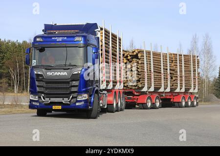 LIETO, FINLAND, APRIL 12, 2018: Blue Scania R730 logging truck makes left turn on test drive during Scania Tour 2018 in Turku Stock Photo