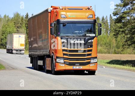 Customised orange Scania S500 truck of KaroTrans pulls semi trailer in highway lorry traffic on a day of summer. Jokioinen, Finland. May 19, 2023 Stock Photo