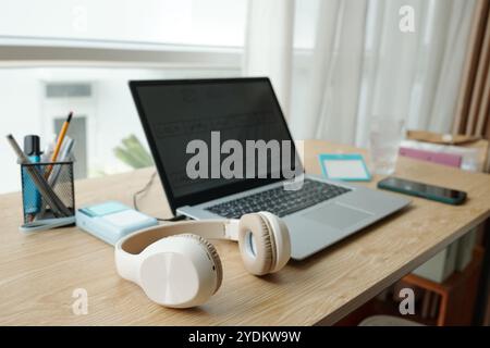 Modern Workspace Featuring Laptop and Headphones Stock Photo