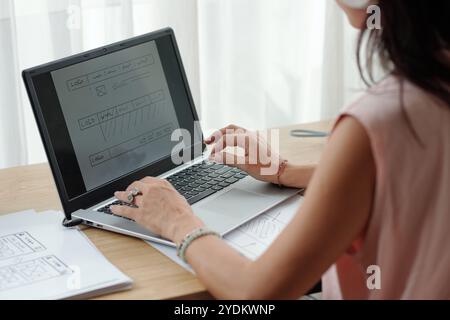 Analyzing Website Design on Laptop with Keen Focus Stock Photo