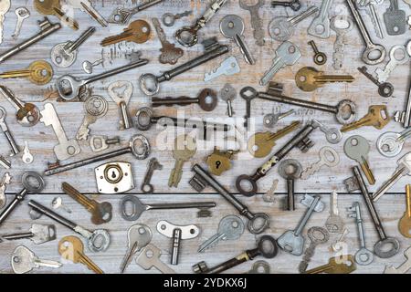 Overhead view of many different old keys in a mess on wooden background concept Stock Photo