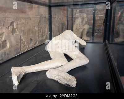 Plaster cast of a victim of the eruption in the Macellum (marketplace) in the ruins of the ancient city of Pompeii in Campania Region, Southern Italy Stock Photo