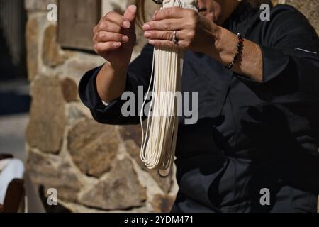 Close view of a cook showing how prepare the Filindeu, a rare type of pasta from the Barbagia region of Sardinia used for typical recipes Stock Photo