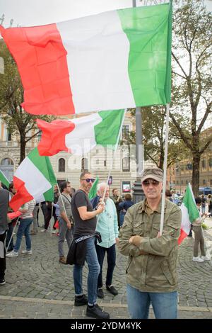 Rome, Italy. 26th Oct, 2024. Protesters wave Italian flags during the protest against the ongoing wars and to reiterate that 'Italy repudiates war' organized by the anti-establishment political party Sovereign Popular Democracy in Rome. (Credit Image: © Marcello Valeri/ZUMA Press Wire) EDITORIAL USAGE ONLY! Not for Commercial USAGE! Stock Photo