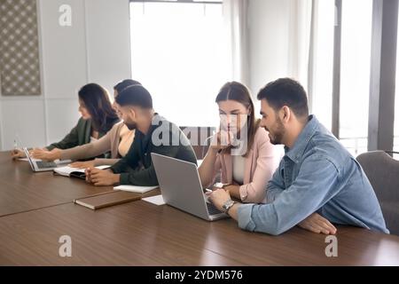Young couple of business colleagues in casual working on project Stock Photo