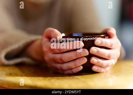 Woman holding coffee cup Stock Photo