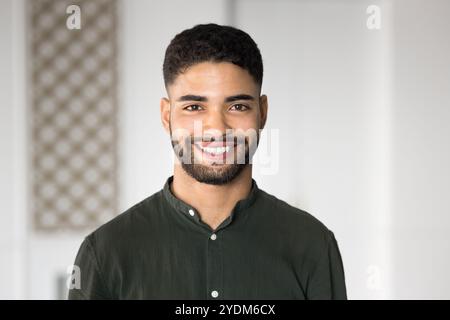 Happy handsome young Arabic businessman posing for head shot Stock Photo