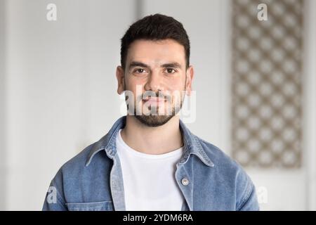 Positive handsome young Middle Eastern entrepreneur man in casual cloth Stock Photo