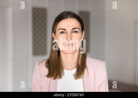Young Caucasian business leader woman looking at camera Stock Photo