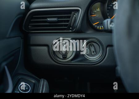 Dashboard controls for headlight settings and air ventilation in a luxury vehicle. Stock Photo