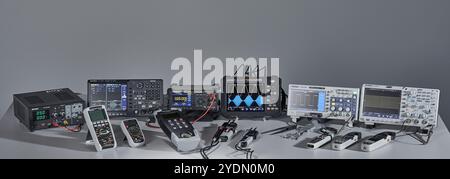Various measuring devices and oscilloscopes set up on a work table in a work situation Stock Photo