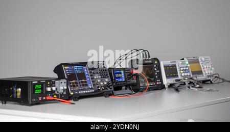 Various measuring devices and oscilloscopes set up on a work table in a work situation Stock Photo