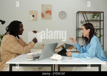 Engaging in Lively Business Discussion in Modern Office Stock Photo