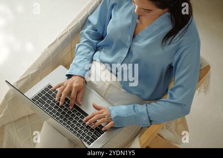 Woman Wearing Blue Shirt Working on Laptop Stock Photo
