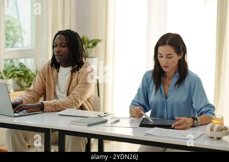 Collaborating in Modern Office Environment with Technology Stock Photo