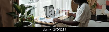 Focused Man Engaging in Remote Work at Home Office Stock Photo