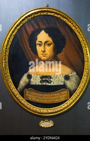 An oval painted portrait at the Museo di Palazzo Poggi depicts Elena Cornaro Piscopia, according to the plaque visible on the picture painted in Padua in 1678. The Venetian scholar was the first woman in the world to earn an academic doctoral degree, awarded by the University of Padua in 1678. Via Zamboni, Bologna, Emilia-Romagna, Italy. Stock Photo