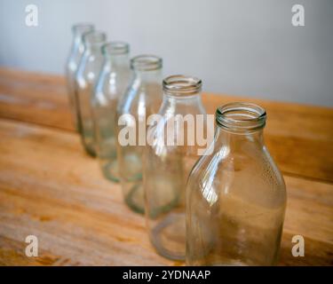 Empty glass bottles for recycling and reuse - milk bottles from United Kingdom in a crate ready for collection by a milk man Stock Photo