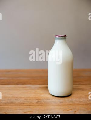 Empty glass bottles for recycling and reuse - milk bottles from United Kingdom in a crate ready for collection by a milk man Stock Photo