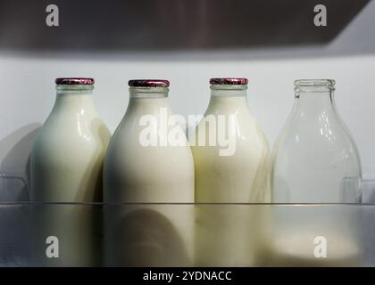 Empty glass bottles for recycling and reuse - milk bottles from United Kingdom in a crate ready for collection by a milk man Stock Photo