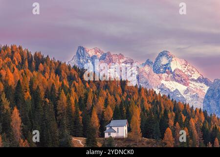 The little chapel of the Pius XII Institute near Lake Misurina on an autumn evening after sunset located in the province of Belluno in the Dolomites, Stock Photo