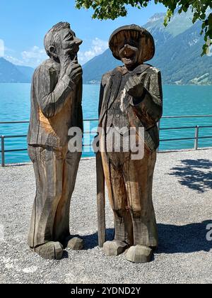 Lakeside Wooden Sculptures of Two Elderly Figures in Conversation Stock Photo