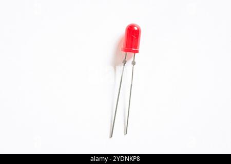 Macro shot of a small red coloured LED light, isolated against white background. Stock Photo