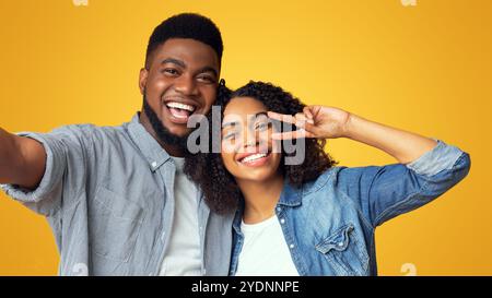 Couple selfie. Cheerful african american guy taking photo with his girlfriend Stock Photo