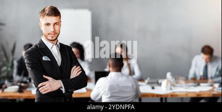 Confident Business Man Standing In Front Of Employess In Office Stock Photo