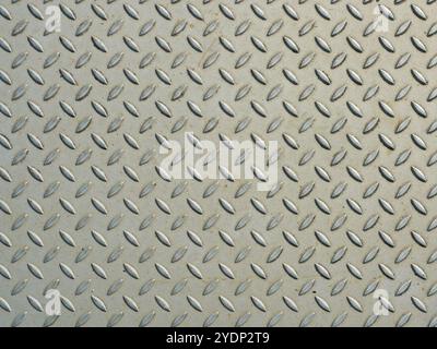The surface of the checker plate with its precise grooves offers a beautiful texture. Ideal as a background for industrial or technical designs. Stock Photo