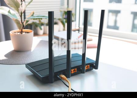 Black wifi router with four antennas. Fast wireless network concept Stock Photo