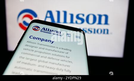 In this photo illustration, a smartphone with the website of US company Allison Transmission Holdings Inc. is seen in front of business logo. Stock Photo