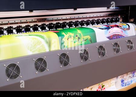 A large printer with a green lime and a green leaf on it. The printer is black and silver Stock Photo