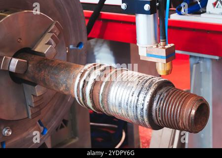 Industrial machine repairs metal parts using laser plasma cladding, Industrial metalworking concept background Stock Photo