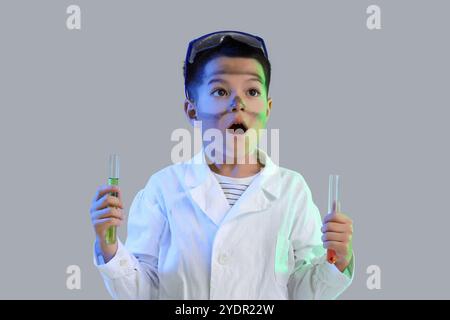 Surprised little boy with dirty face after explosion during chemistry experiment on grey background Stock Photo